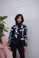 Nadya Shah Alto Mare jacket showing a stylish waterproof jacket with a hood and zipper, perfect for outdoor wear.