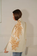 Nadya Shah Alya ivory tuxedo cape jacket with elegant lapels and draped design, perfect for formal and evening wear.