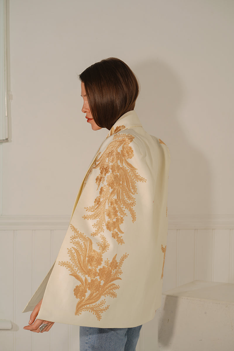 Nadya Shah Alya ivory tuxedo cape jacket with elegant lapels and draped design, perfect for formal and evening wear.