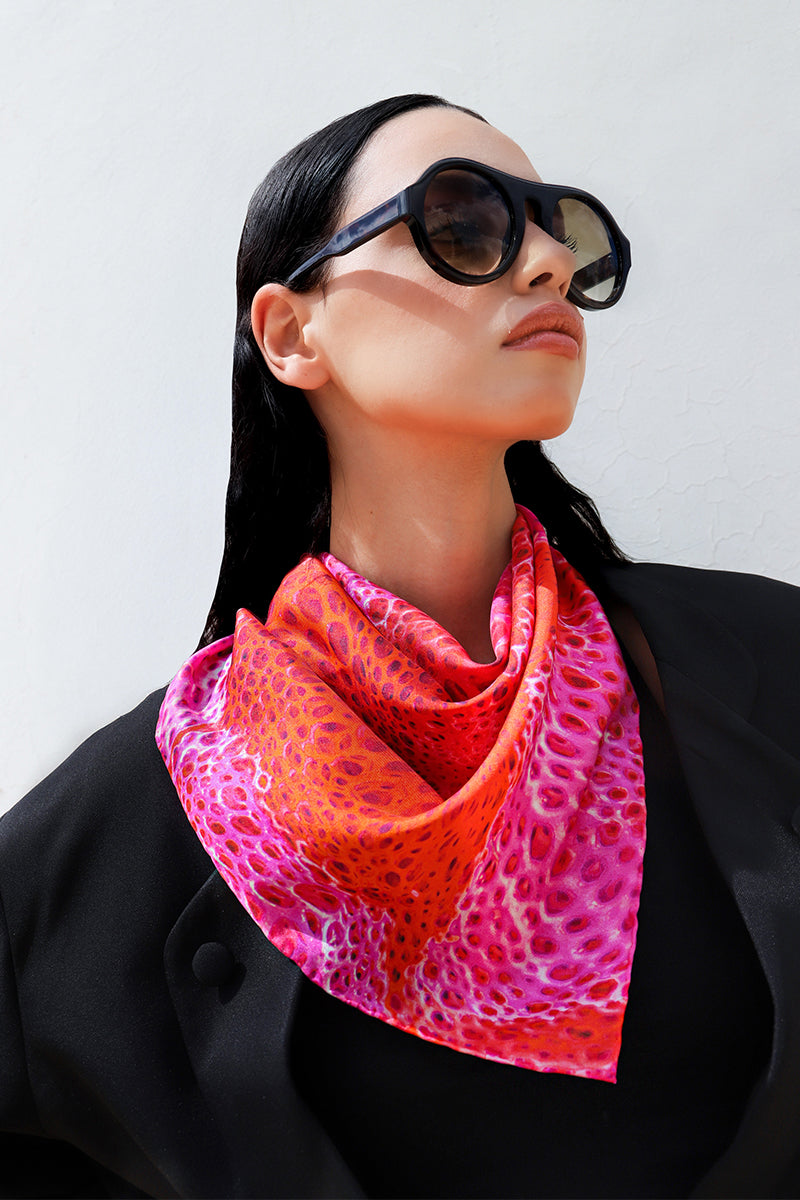 Amel Batita Amore Moussard small silk scarf draped around neck, featuring elegant pattern and vibrant colors.