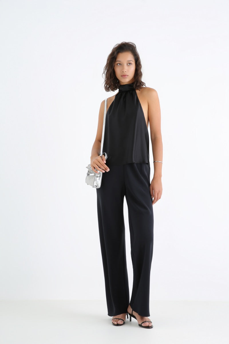Serenity Amore black silk-satin backless halter-neck top displayed on a hanger, showcasing its elegant fabric and stylish design.