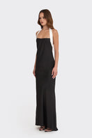 Black Angeline maxi dress by Stolen Stores, flowing length and sleeveless design, styled on a model.