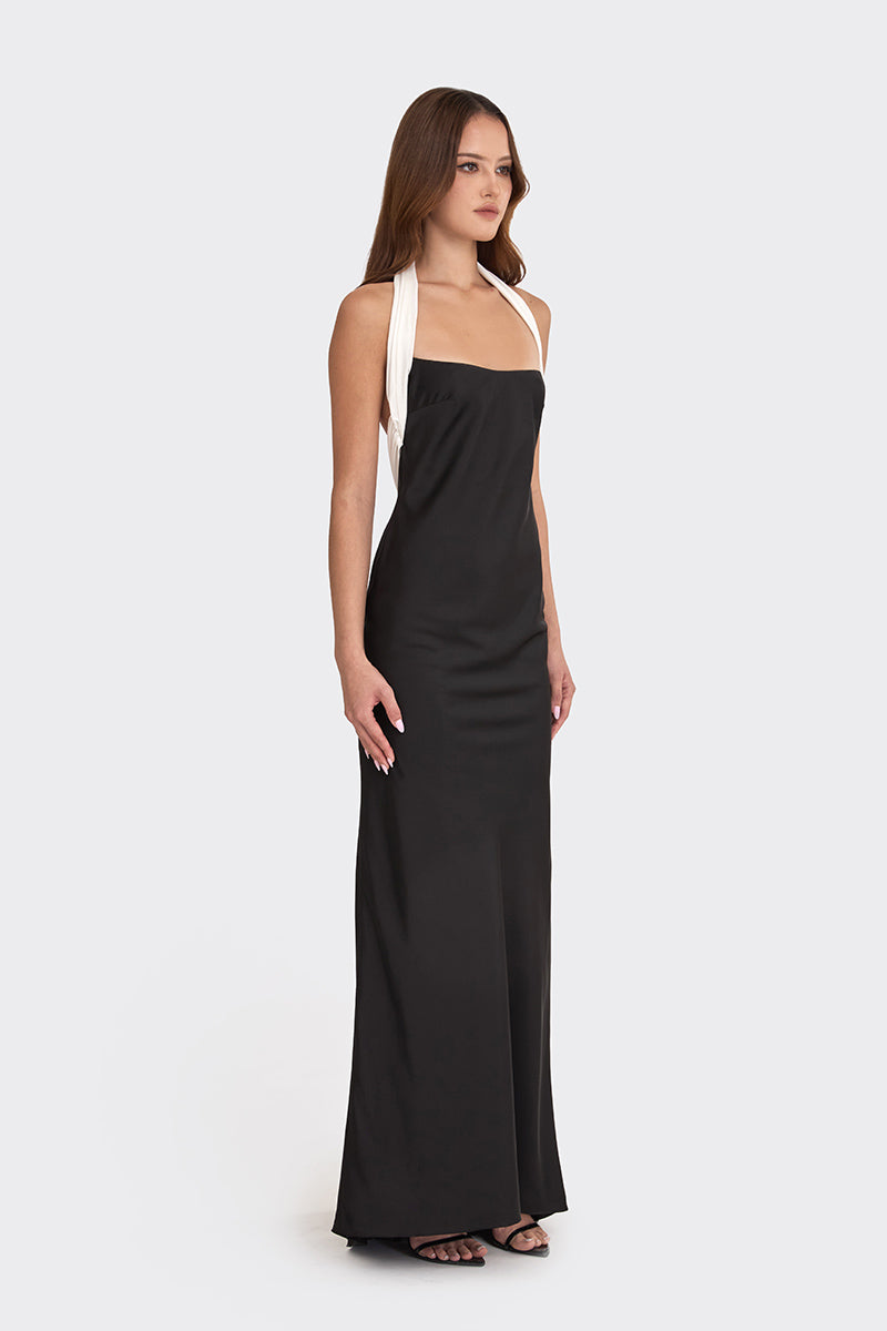 Black Angeline maxi dress by Stolen Stores, showing the long flowing fabric and elegant design on a model.