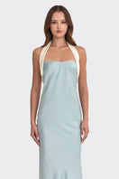 Blue Angeline Maxi Dress by Stolen Stores displayed on a hanger, showcasing the flowing dusty blue fabric and elegant design.