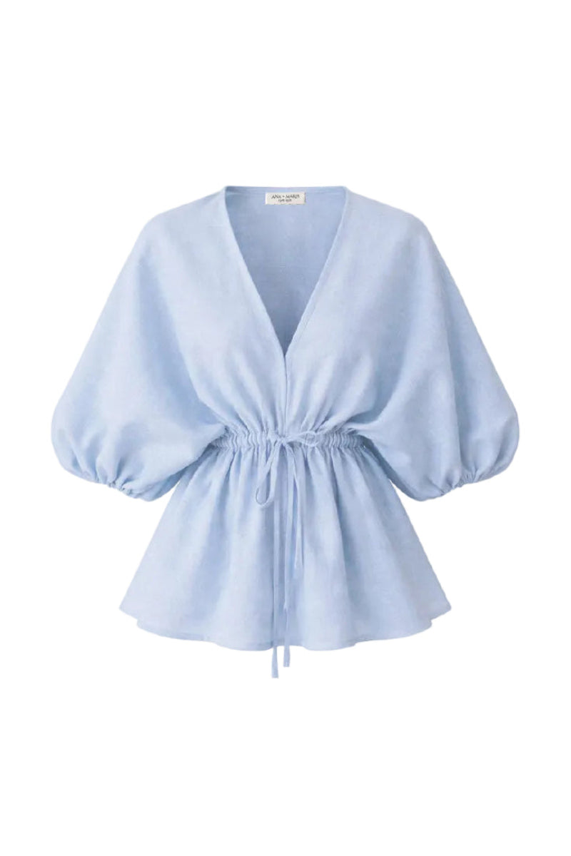 Light blue Ani blouse from ANA + MARIA, featuring a stylish tops design with soft fabric and modern fit.