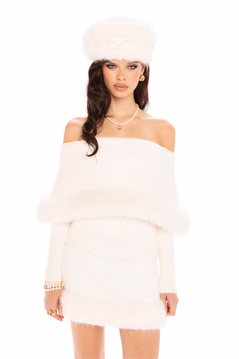 White Nana Jacqueline Anika knit top displayed on a model, showcasing its soft texture and stylish fit.