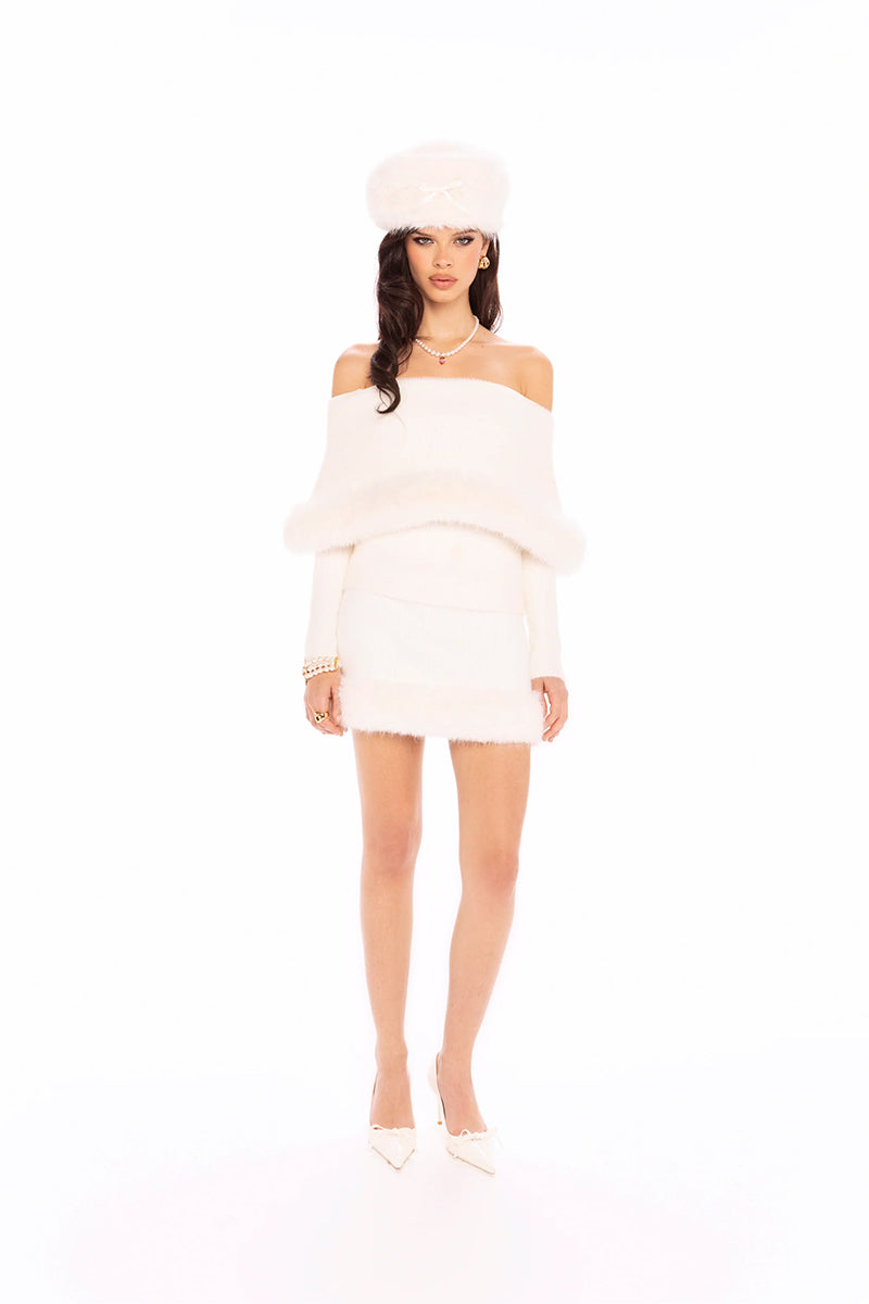 White Nana Jacqueline Anika knit top shown on a model, featuring a fitted design with a rounded neckline and long sleeves.