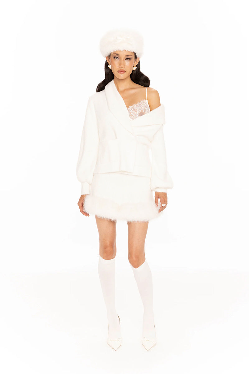 White Nana Jacqueline Anika mini skirt shown on a model, featuring a stylish and fitted design perfect for casual or dressy outfits.