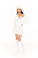 Nana Jacqueline Anika white mini skirt, stylish and fitted, shown on a model with a casual outfit.