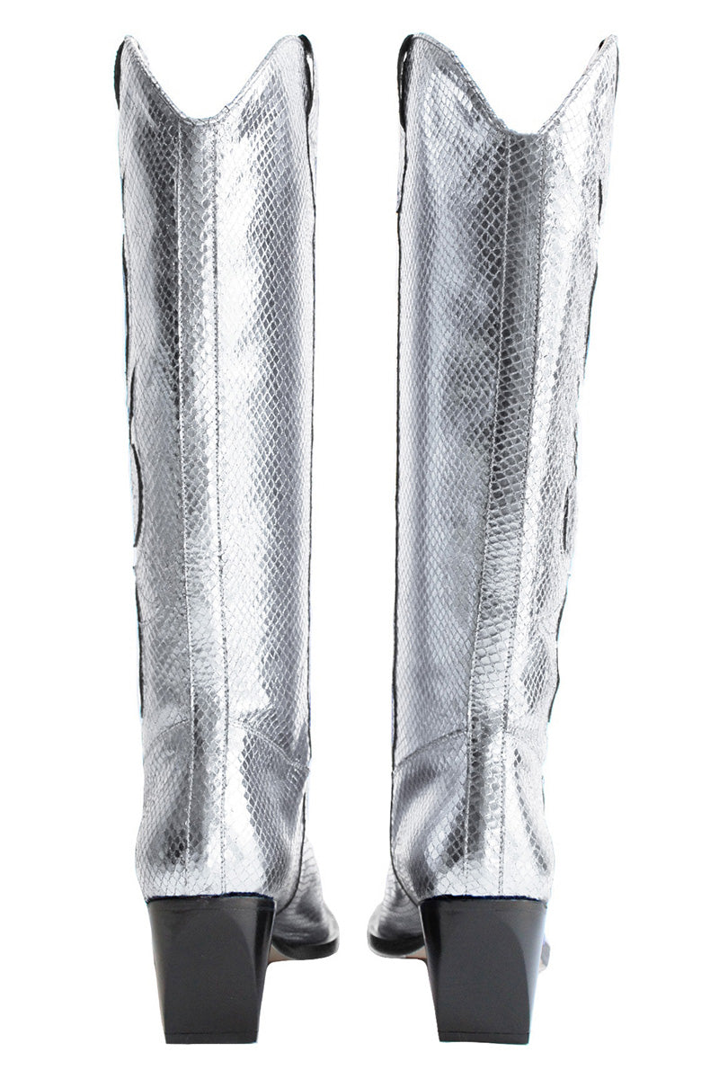 Silver Annie cowboy boots by Terry de Havilland with pointed toes and decorative stitching, styled for a fashionable look.