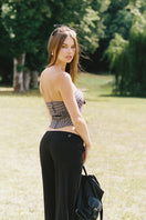 Nana Jacqueline Anya black pants displayed on a model, featuring a sleek, tailored fit for modern, stylish wear.