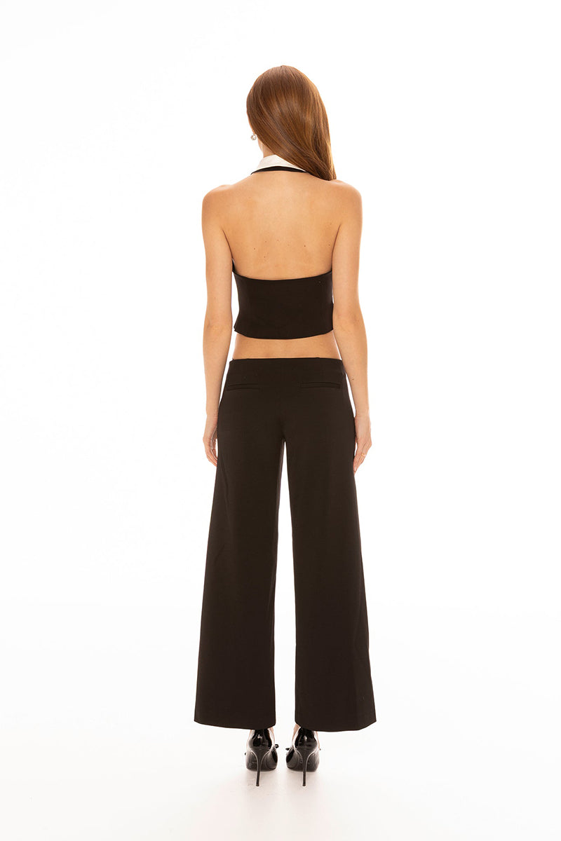 Black Nana Jacqueline Anya pants with a fitted silhouette, shown on a model in a stylish casual look.