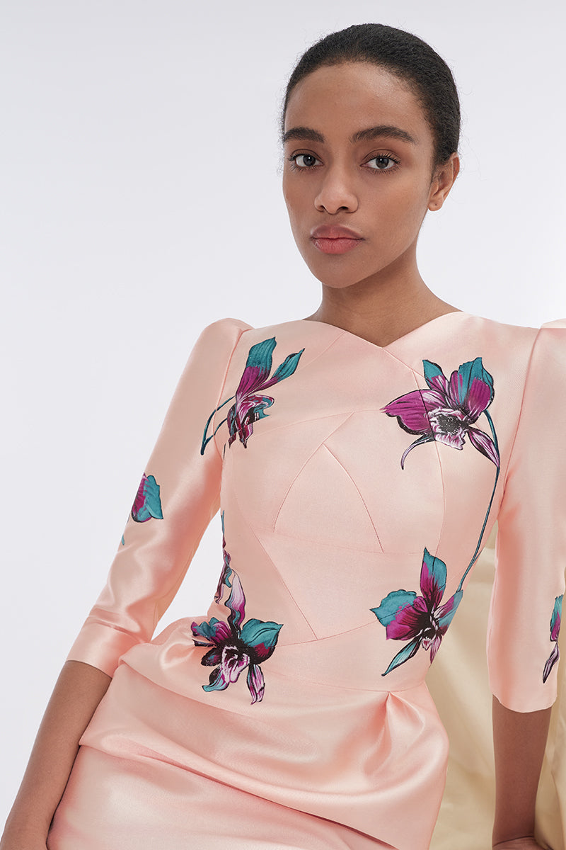 Apricot blush sculpted V-neck pegged midi dress by Tiny Ink displayed on a hanger, showcasing its fitted silhouette and elegant design.