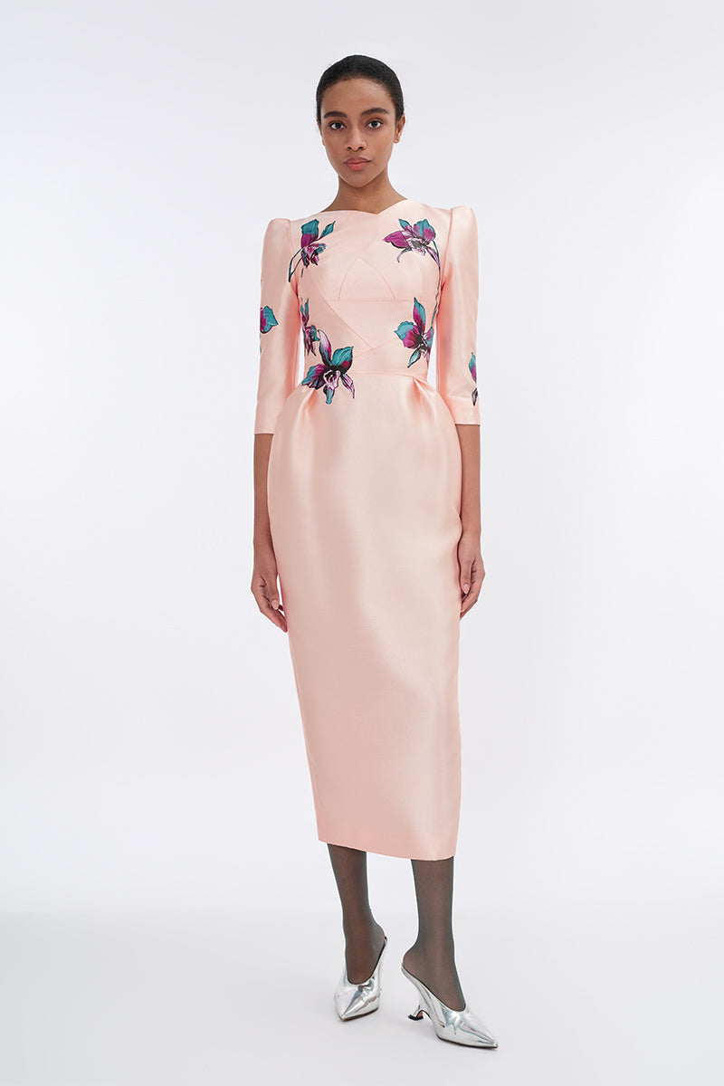 Apricot blush sculpted V-neck pegged midi dress by Tiny Ink displayed on a hanger with a fitted waist and flowy skirt.
