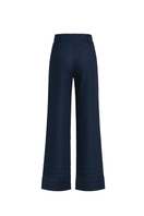 Navy blue ANA + MARIA Ara pants displayed on a model, showcasing a stylish, casual fit with front pockets and tapered legs.