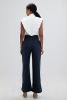 Navy blue ANA + MARIA Ara pants, stylish and fitted, shown on a model against a neutral background.