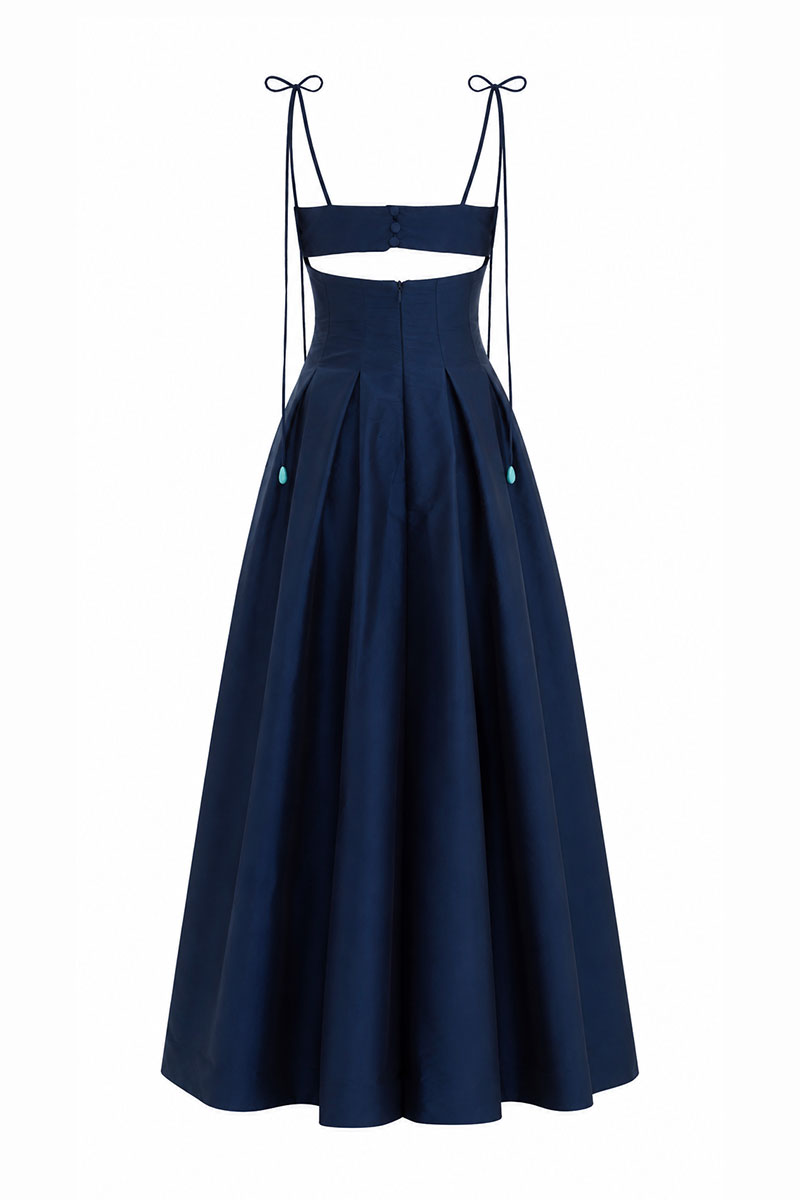 Brown and navy Arena dress by Maylé Vásquez featuring elegant gown design with flowing fabric and stylish details.