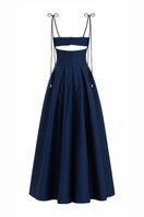 Brown and navy Arena dress by Maylé Vásquez featuring elegant gown design with flowing fabric and stylish details.