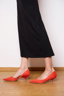 A pair of orange suede-effect AERA heels with pointed toes and stiletto heels, displayed on a neutral background.