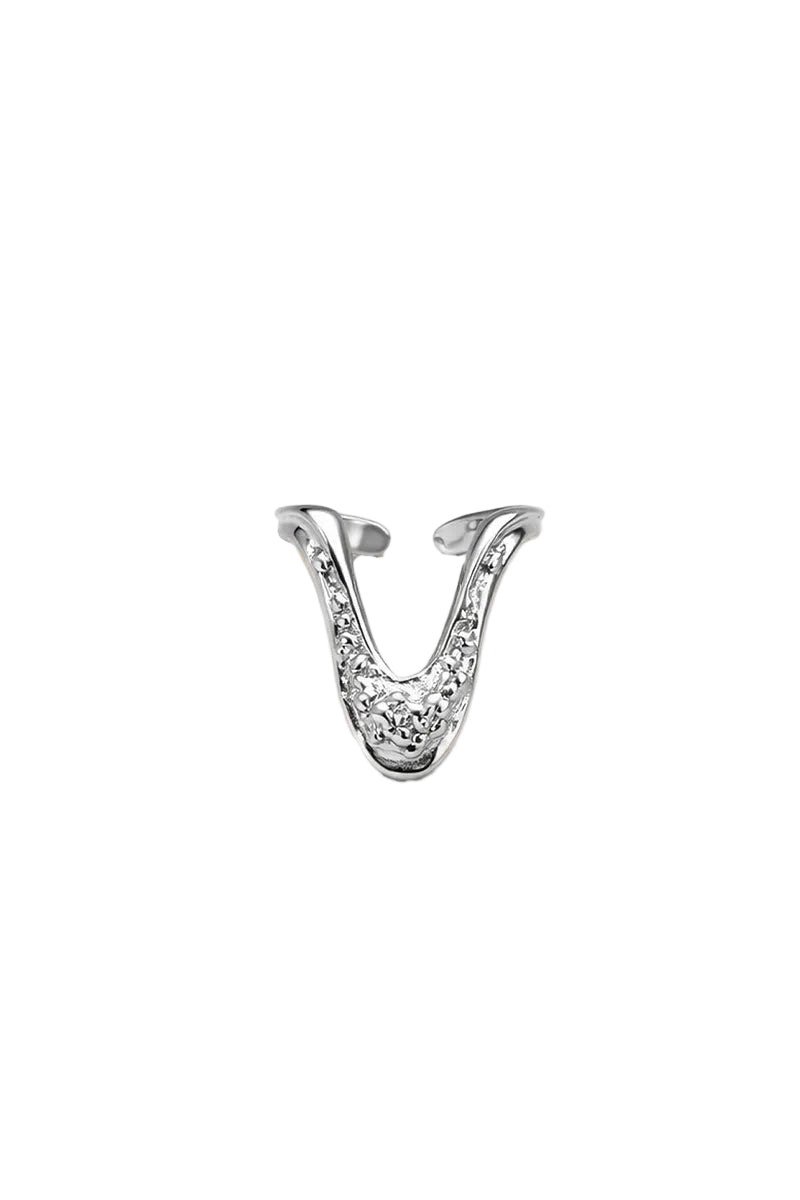 Silver drape ring by Jude Benhalim featuring elegant, flowing design with a smooth finish, showcased on a plain background.