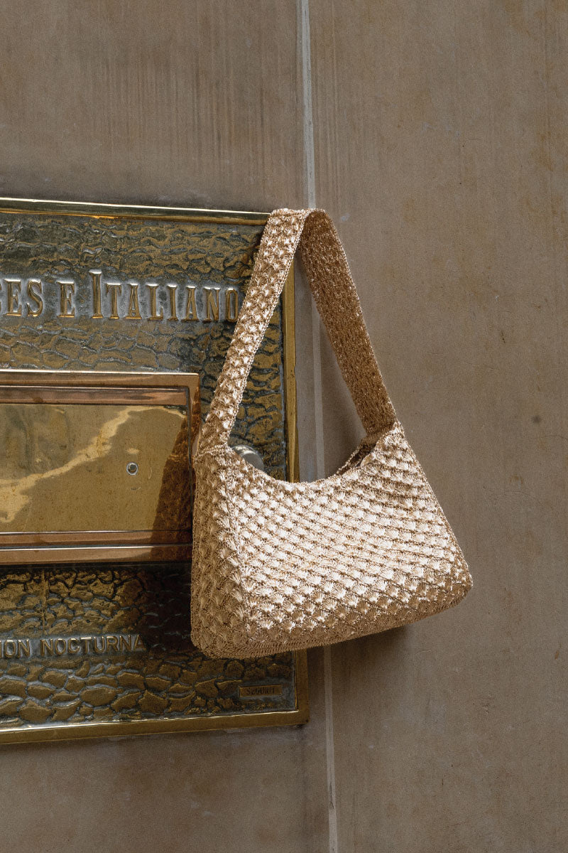 Gold Arista seashell shoulder bag by VERDI with textured shell design and elegant shoulder strap.
