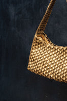 Verdi Arista seashell shoulder bag in antique brass with detailed shell design and adjustable strap, stylish and unique accessory.