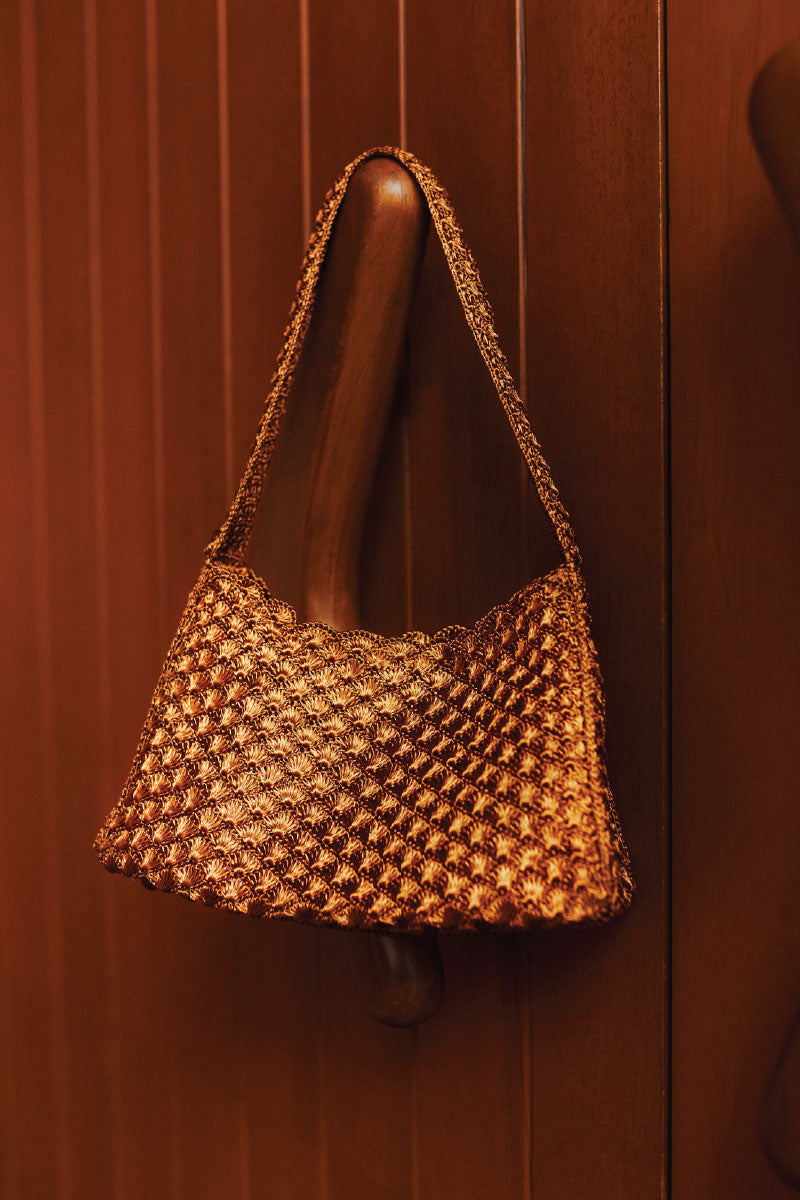 Verdi Arista seashell shoulder bag in copper with textured shell design and adjustable strap for stylish accessories.