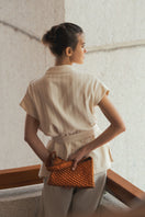Verdi Arista seashell-shaped copper shoulder bag with textured surface and elegant design.