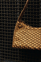 Verdi Arista seashell shoulder bag in antique brass with intricate shell design and adjustable strap.