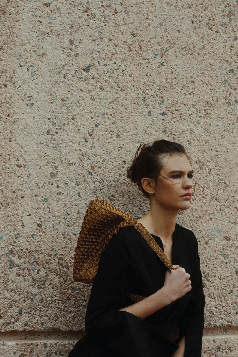 Verdi Arista seashell shoulder bag with antique brass finish, featuring intricate shell design and stylish strap detail.