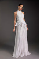 Le Thanh Hoa Snow Bloom gown featuring a flowing white design with delicate floral embroidery and elegant long sleeves.
