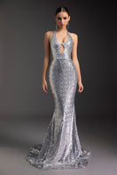 Shimmering goddess gown by Le Thanh Hoa featuring flowing fabric and elegant design, perfect for formal occasions.