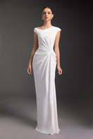 Elegant luminous pearl gown by Le Thanh Hoa featuring shimmering pearl details and flowing fabric, perfect for formal occasions.