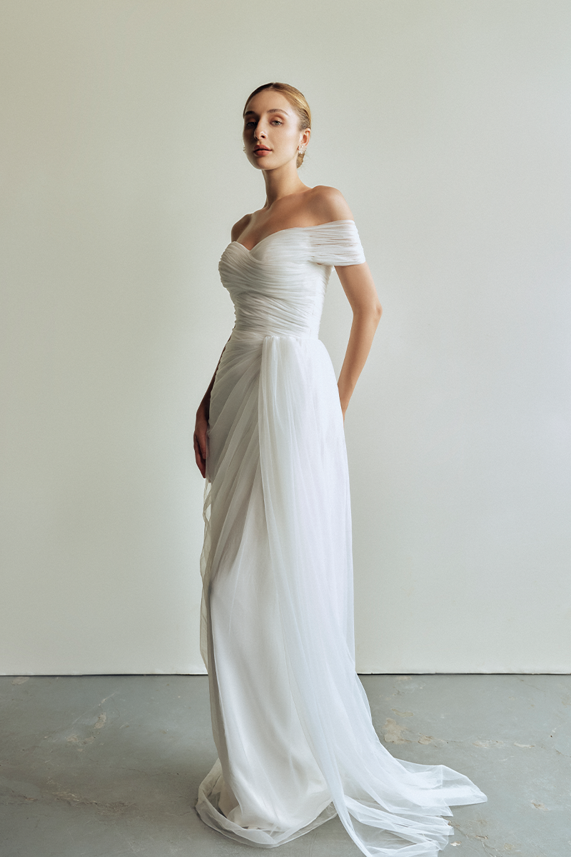 Le Thanh Hoa Sophia Simply White long gown with flowing fabric and elegant design, perfect for formal occasions.