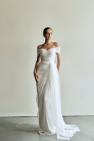 Le Thanh Hoa Sophia Simply White long gown with flowing fabric and elegant design, showcased on a mannequin.