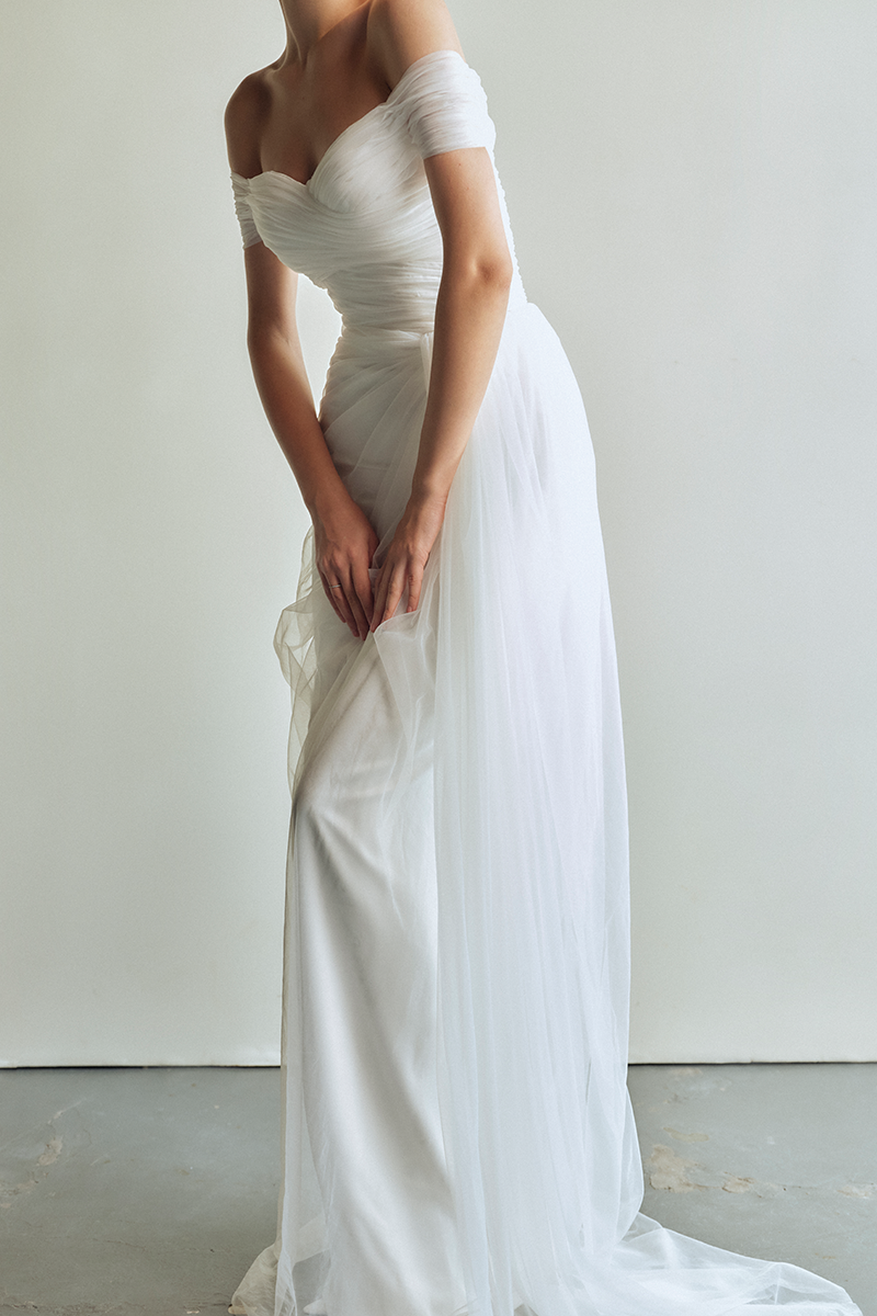 Le Thanh Hoa Sophia Simply White long gown with elegant flowing fabric and classic design, perfect for formal occasions.