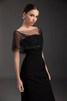 Black Dahlia gown by Le Thanh Hoa featuring elegant black fabric and intricate design, perfect for formal occasions.