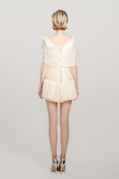 Do Long Falling Petals mini dress featuring a floral pattern and flowy fabric, displayed on a hanger against a neutral background.