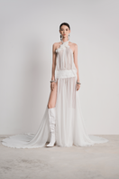 Le Thanh Hoa Glacial Grace gown in white with flowing fabric and elegant design, displayed on a mannequin.