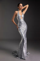 Elegant shimmering goddess gown from Le Thanh Hoa featuring flowing fabric and intricate detailing, perfect for formal occasions.