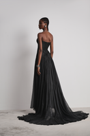 Black Le Thanh Hoa Celestial Whisper gown with flowing fabric and elegant design, showcased on a mannequin.