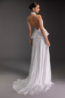 Le Thanh Hoa Snow Bloom gown featuring delicate floral embroidery and flowing fabric, perfect for elegant occasions.