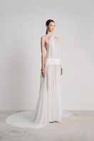 Elegant white Glacial Grace gown by Le Thanh Hoa featuring flowing fabric and intricate detailing.
