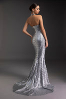 Shimmering goddess gown by Le Thanh Hoa featuring elegant flowing fabric and intricate detailing, perfect for formal occasions.
