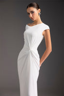 Elegant luminous pearl gown by Le Thanh Hoa featuring intricate beadwork and flowing fabric, perfect for formal occasions.