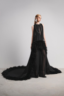 Black Le Thanh Hoa Nocturnal Warmth jumpsuit displayed on a hanger, showing its sleek, full-length design and fitted silhouette.