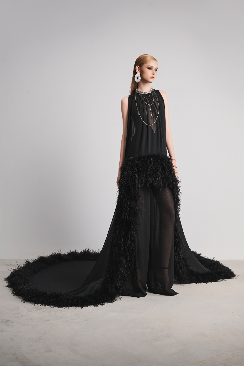 Black Le Thanh Hoa Nocturnal Warmth jumpsuit displayed on a hanger, showing its sleek, full-length design and fitted silhouette.
