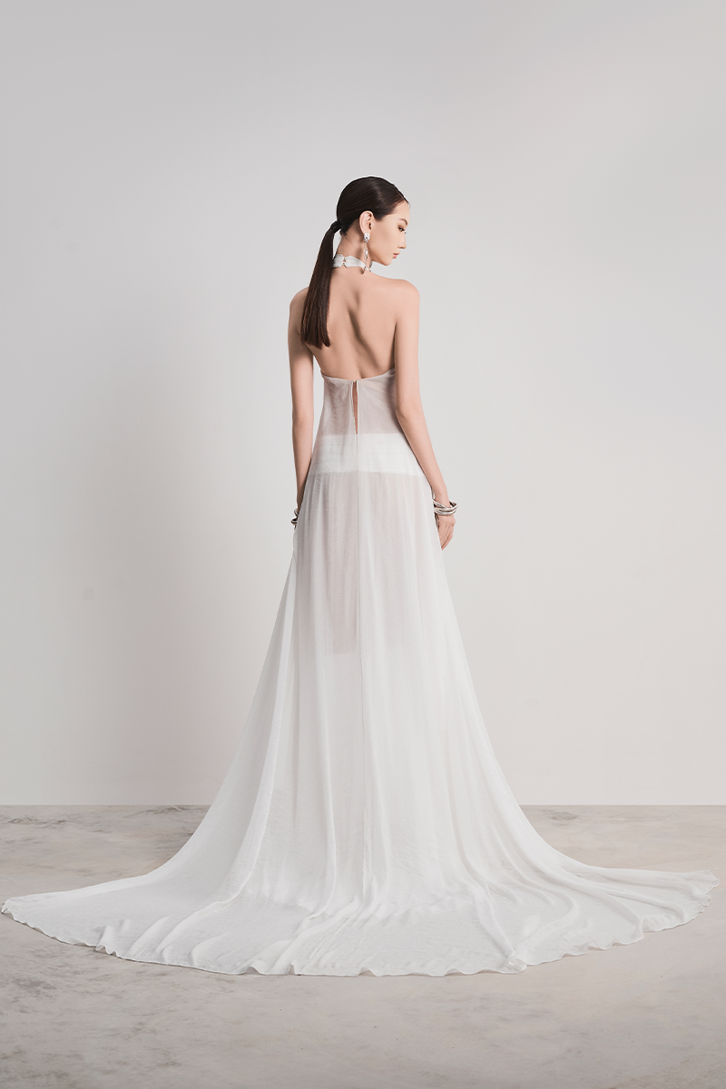 Elegant white Glacial Grace gown by Le Thanh Hoa, featuring flowing fabric and intricate detailing perfect for formal occasions.