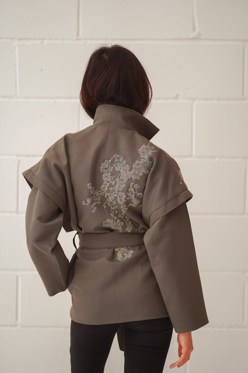 Nadya Shah Ash Bloom belted jacket featuring a stylish design, with a waist belt, in a soft, floral-inspired fabric.