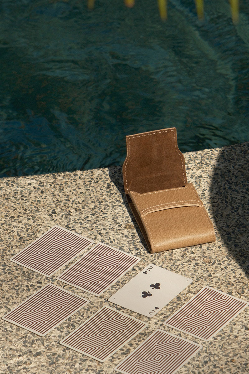 Leather playing card set in Aspen style by Throwing Doubles, featuring elegant leather cards on a lifestyle background.